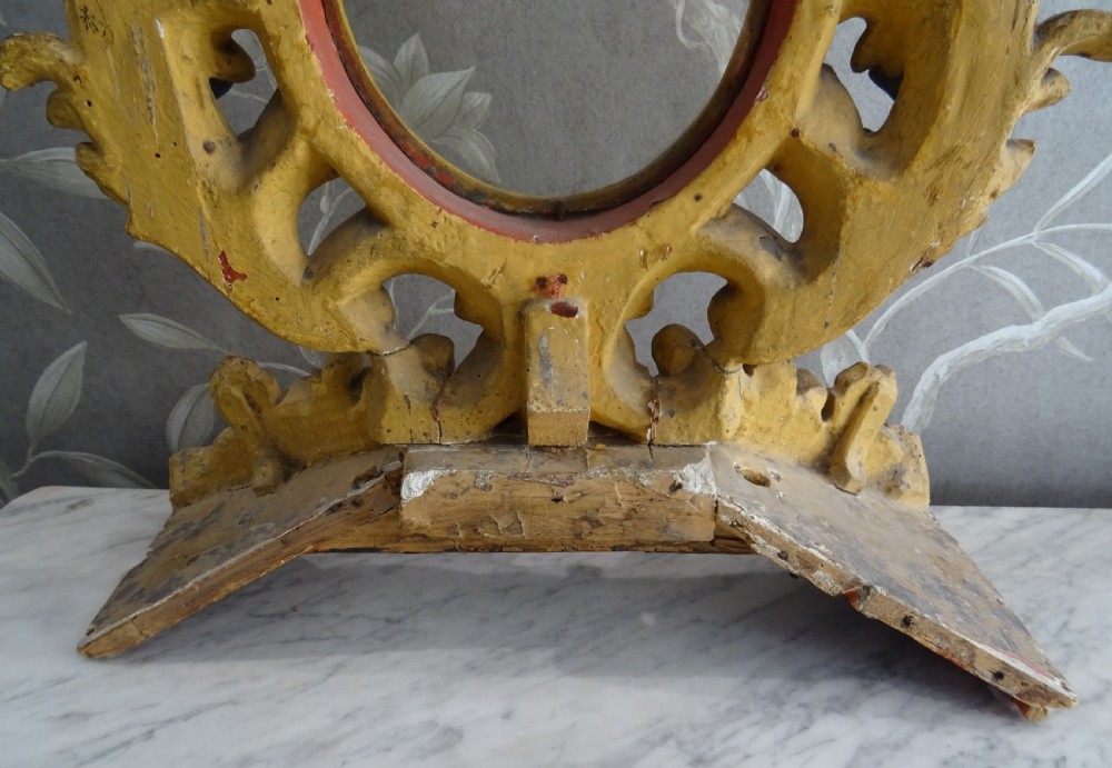 A pair of antique Italian Baroque carved giltwood oval frames with intricate acanthus leaf ornamentation and integrated standing bases. View VII