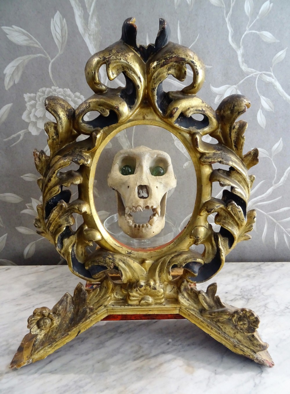 A pair of antique Italian Baroque carved giltwood oval frames with intricate acanthus leaf ornamentation and integrated standing bases. View XI
