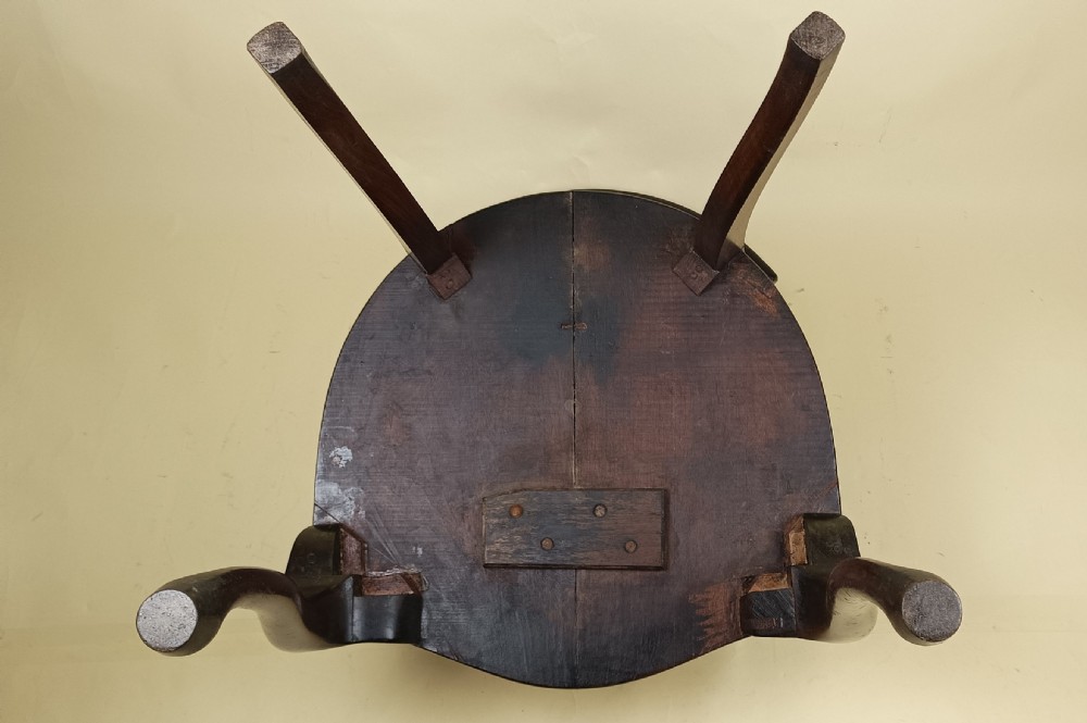 An Edwardian mahogany desk chair featuring a curved leather back panel with brass studs, a carved central splat, and cabriole front legs. View IX