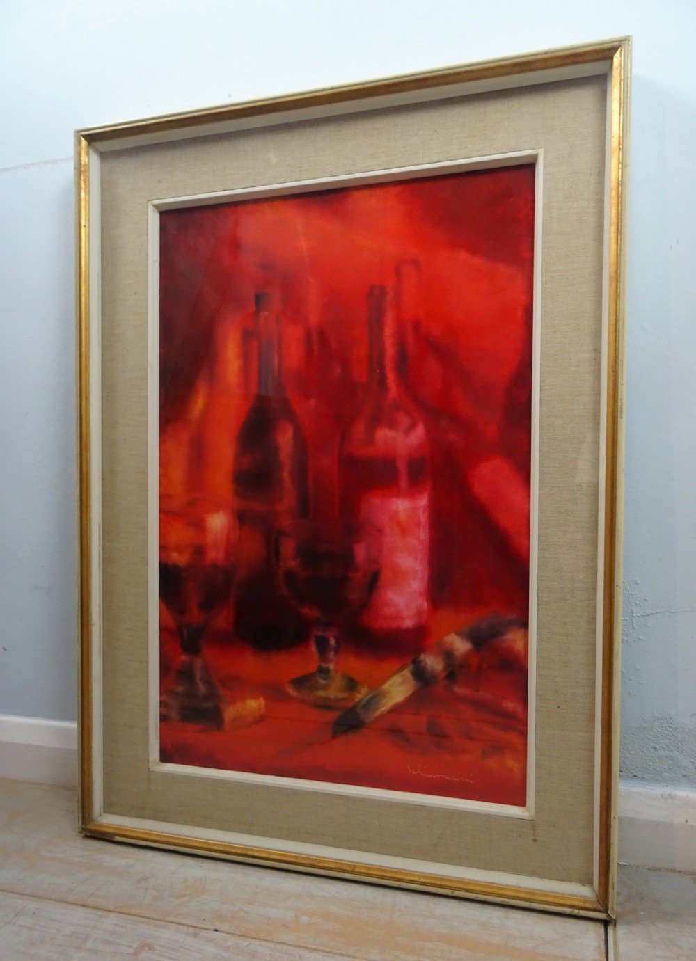 A vertical mid-century oil painting depicting wine bottles, stemmed glasses, and a corkscrew in rich shades of crimson and red. View II