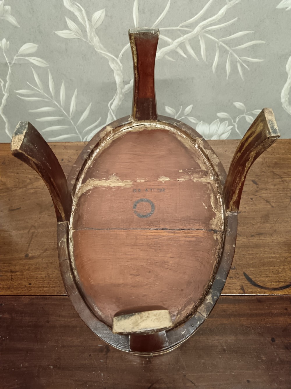 A circular coopered mahogany wine cooler featuring two brass bands and four short splayed legs, containing a metal lining. View VIII