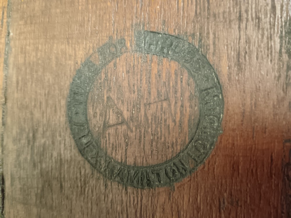 A circular coopered mahogany wine cooler featuring two brass bands and four short splayed legs, containing a metal lining. View IX