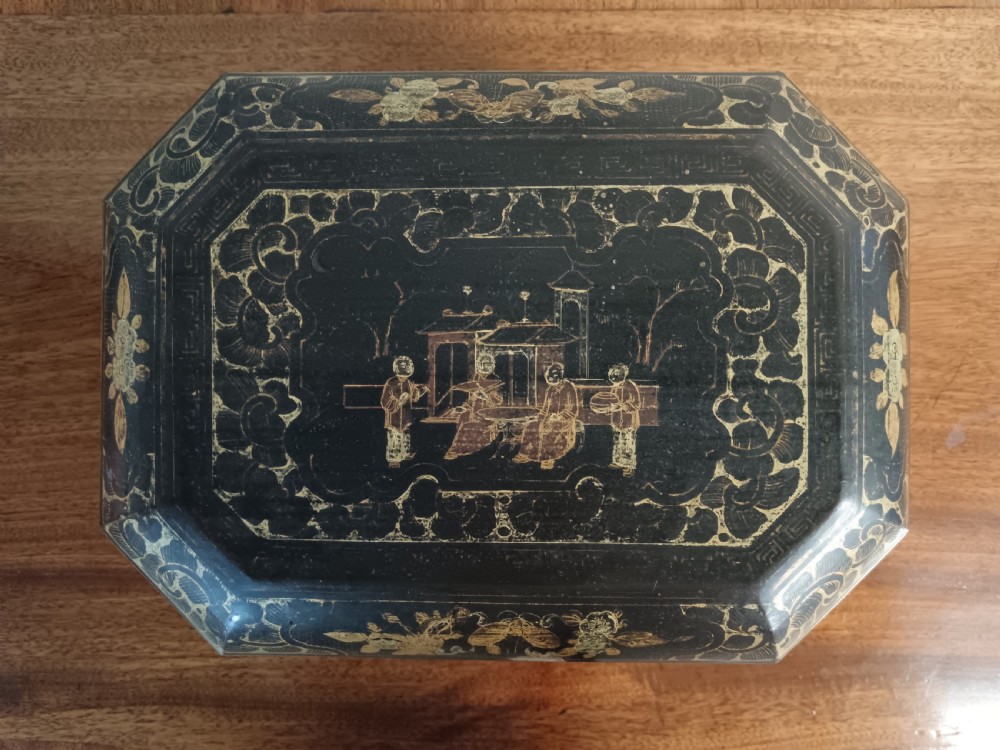 An open octagonal dark lacquer tea box decorated with gilded Chinese motifs containing two engraved pewter metal canisters. View VII
