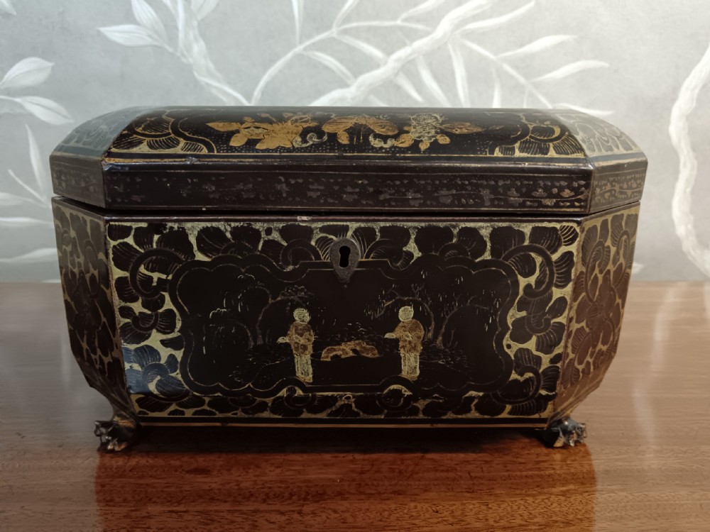 An open octagonal dark lacquer tea box decorated with gilded Chinese motifs containing two engraved pewter metal canisters. View VIII