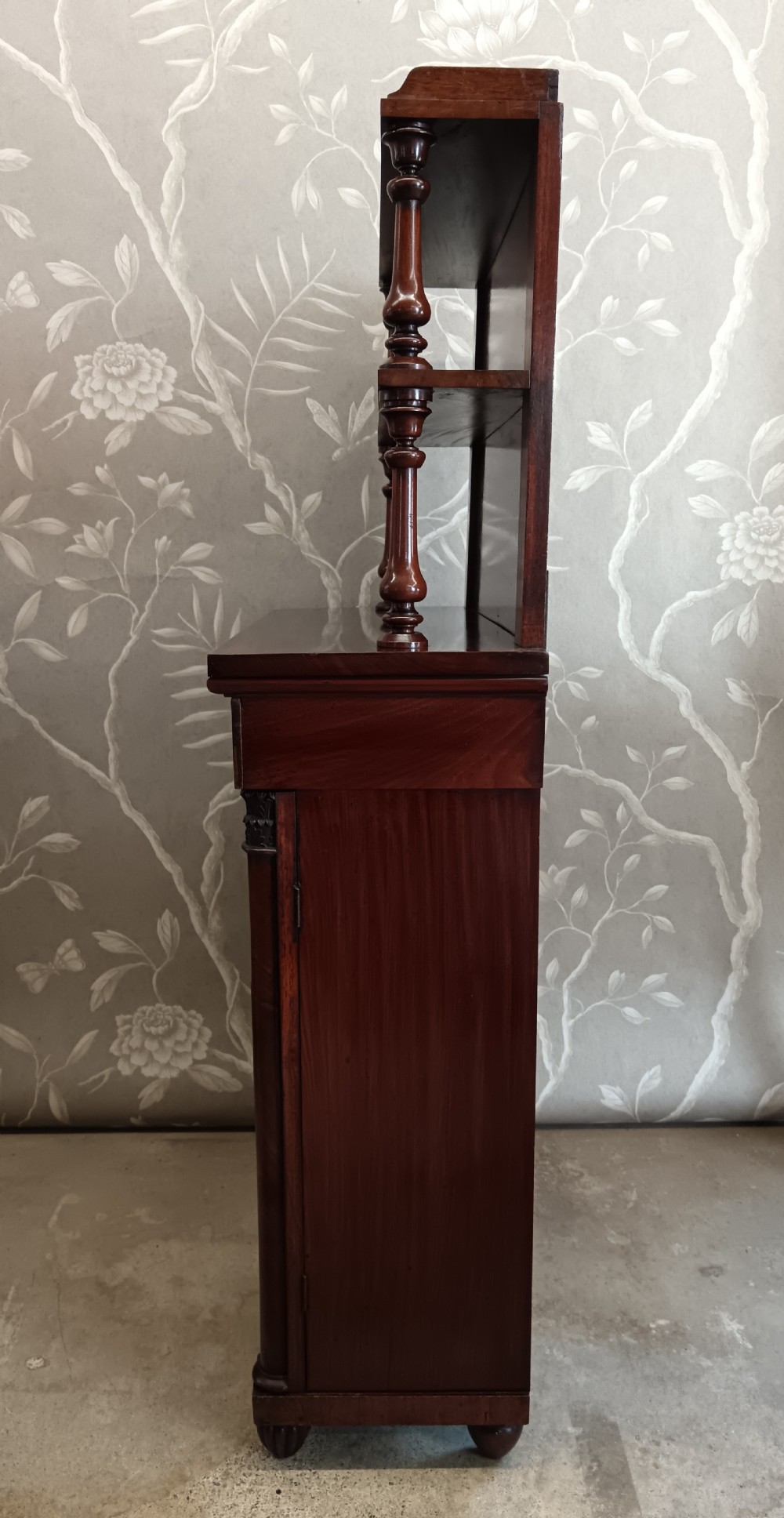 A Regency mahogany chiffonier featuring a two-tier open shelf superstructure above a two-door lower cabinet with arched panel doors and turned columns. View VI