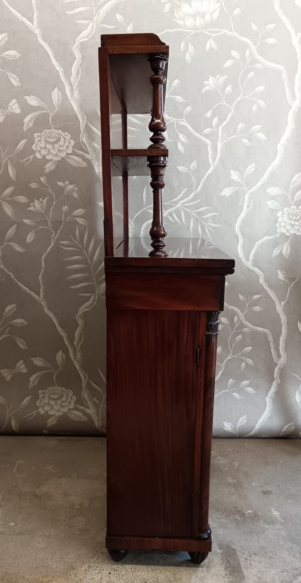 A Regency mahogany chiffonier featuring a two-tier open shelf superstructure above a two-door lower cabinet with arched panel doors and turned columns. View V