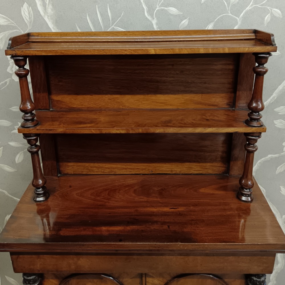 A Regency mahogany chiffonier featuring a two-tier open shelf superstructure above a two-door lower cabinet with arched panel doors and turned columns. View XI