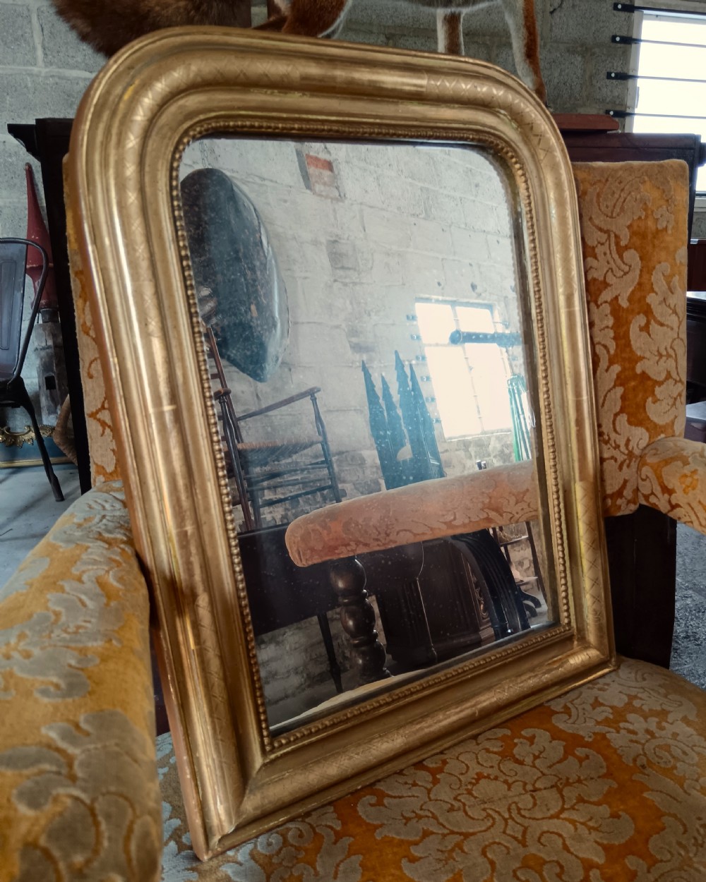A 19th-century French arched wall mirror featuring a giltwood frame with rounded top corners and beaded inner trim. View IX