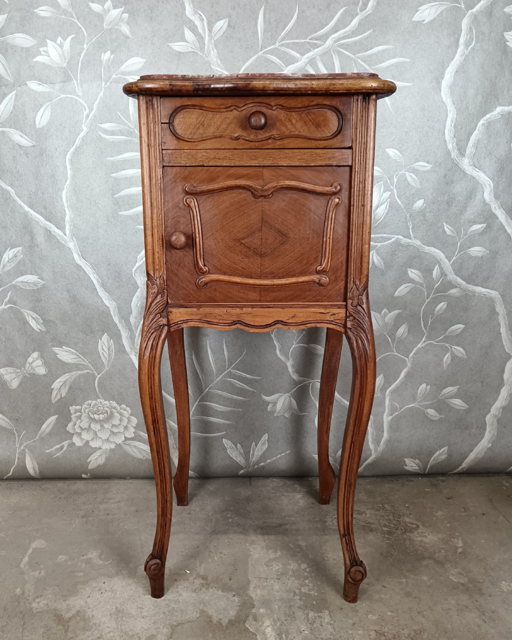 A tall French bedside cupboard crafted from warm brown wood with slim cabriole legs, parquetry panels, a single top drawer, and a lower cabinet door. View II