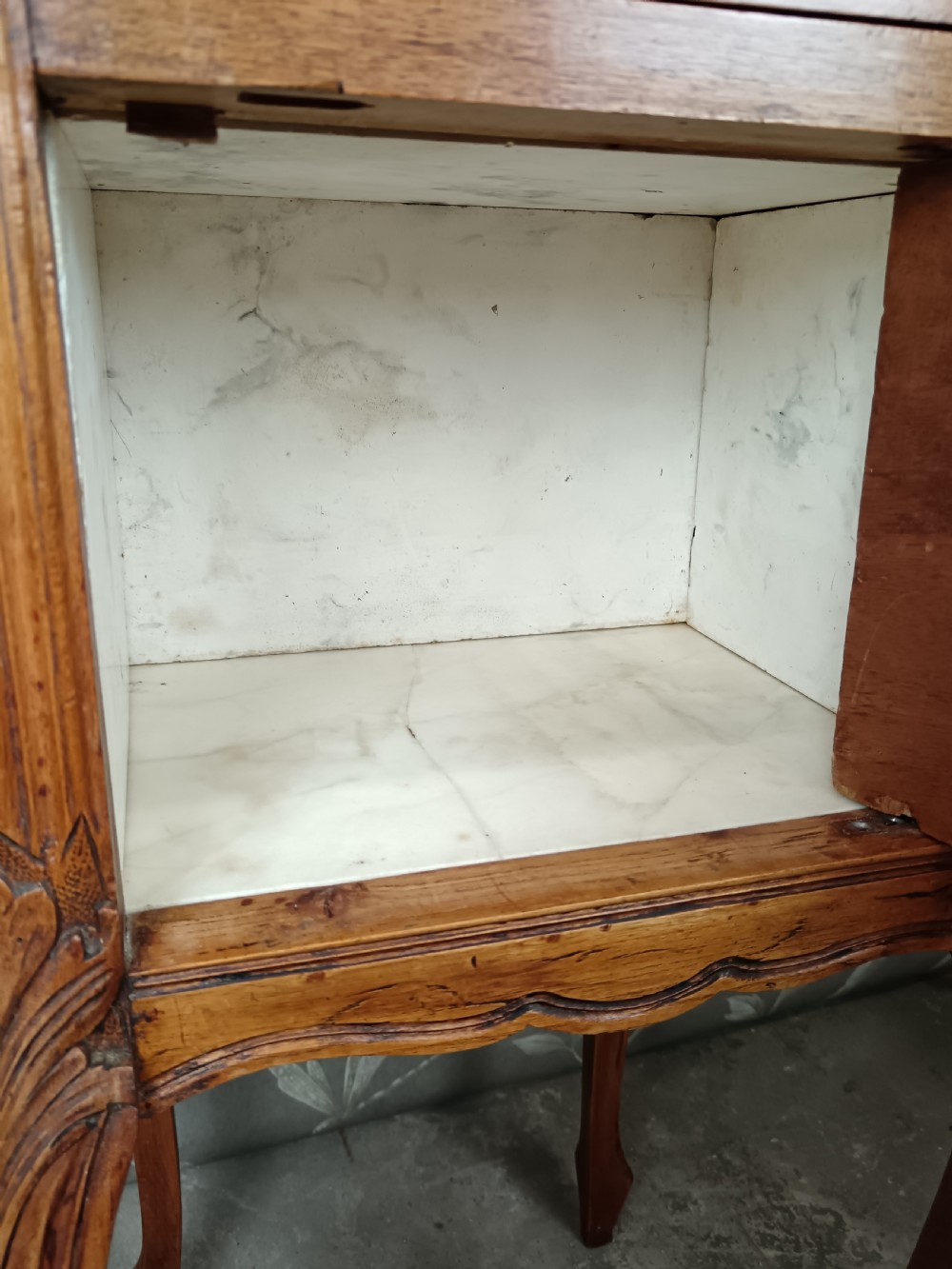 A tall French bedside cupboard crafted from warm brown wood with slim cabriole legs, parquetry panels, a single top drawer, and a lower cabinet door. View XII