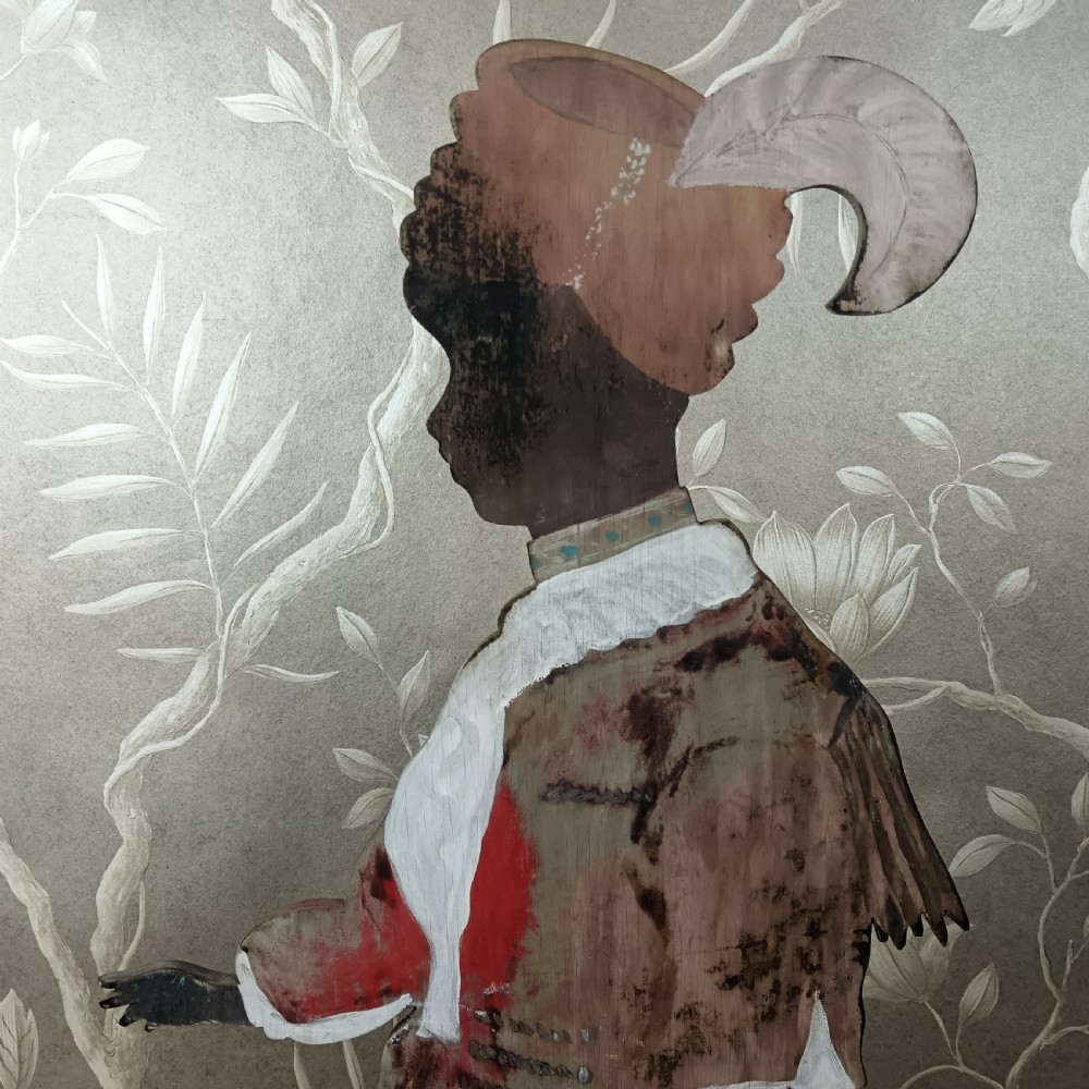 An early twentieth-century painted wooden dummy board figure depicting a man in a red coat and feathered hat holding a kettle. View II