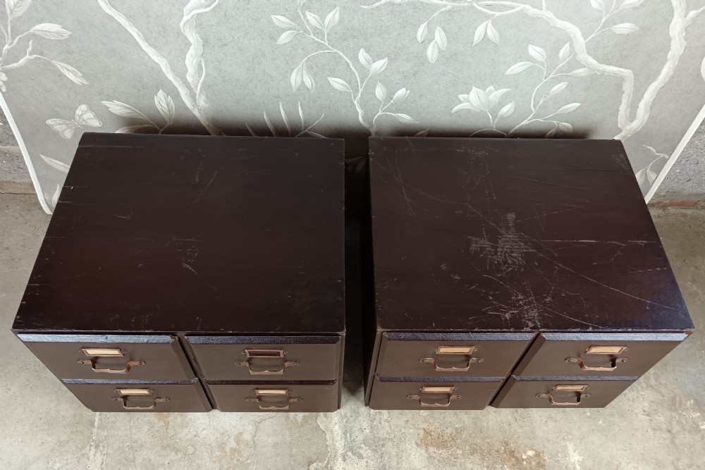 A dark brown modular card index filing cabinet featuring multiple drawers with copper handles and metal label holders. View XII