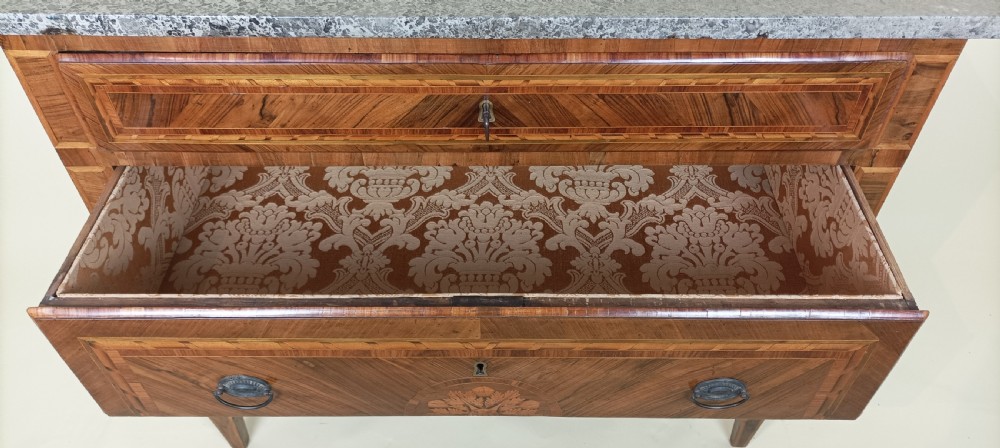 An eighteenth-century Italian Neoclassical marquetry commode with three drawers, geometric timber inlays, a grey marble top, and tapered square legs. View VII