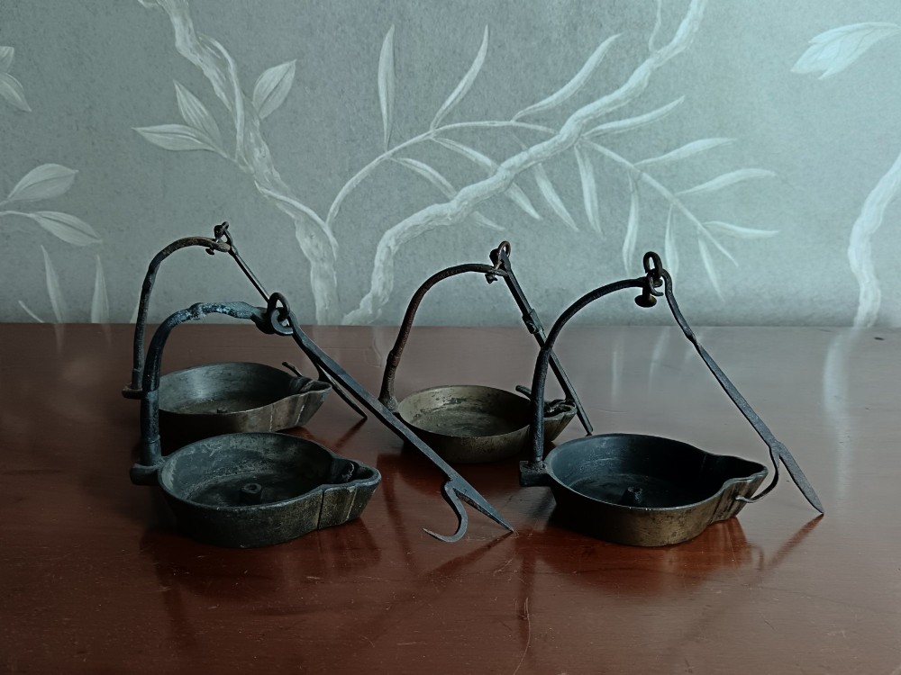A collection of four antique Italian cast brass and bronze hanging Lucerna oil lamps with vertical suspension hooks and open oil reservoirs. View III