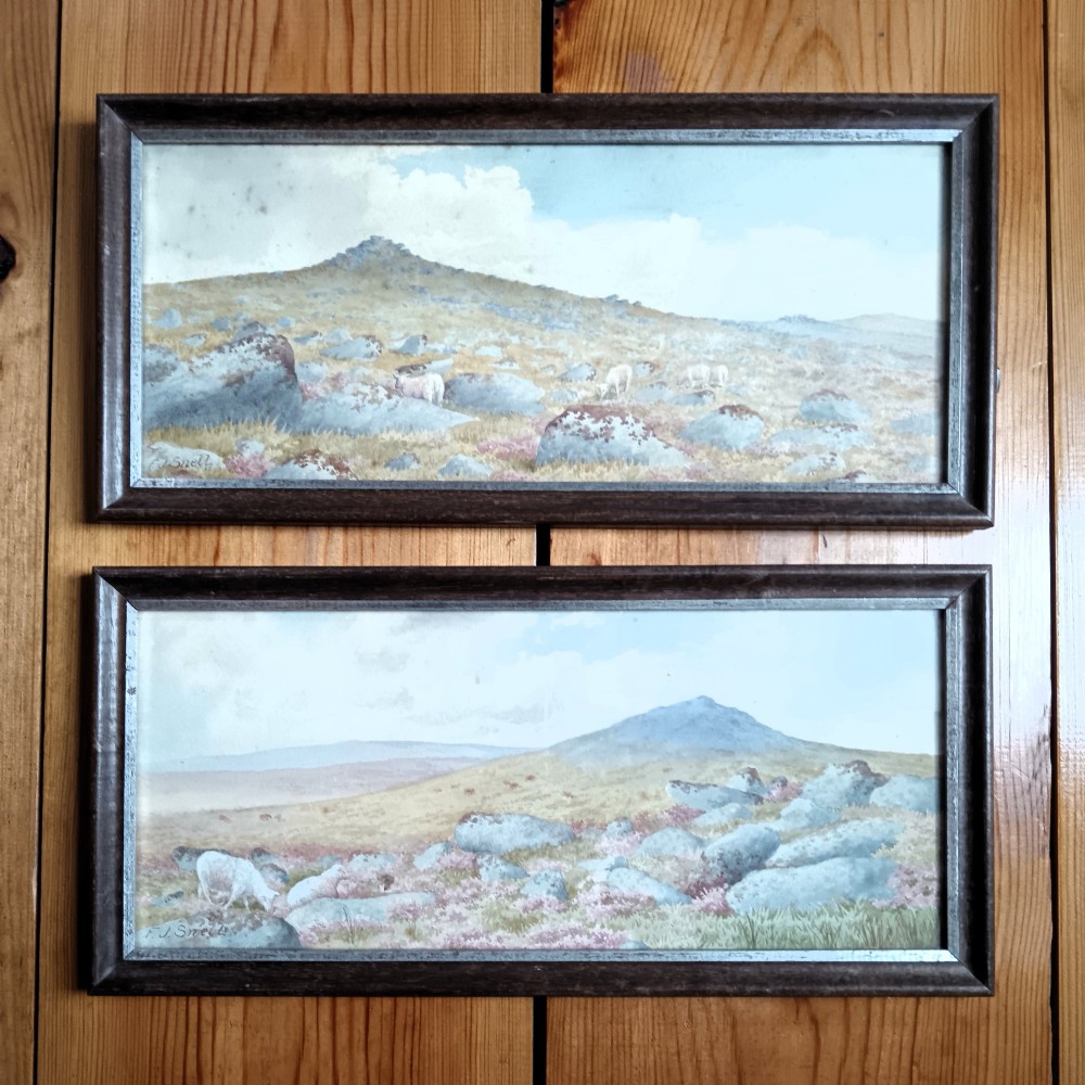 A pair of framed Edwardian watercolour paintings depicting rocky British moorland landscapes with grazing sheep under cloudy skies. View VI