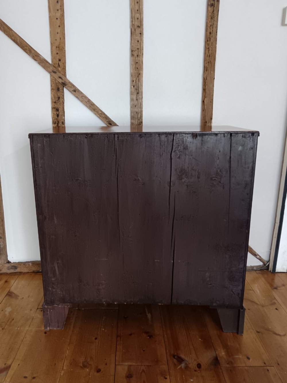 A Georgian mahogany chest of drawers featuring two short drawers above three full-width graduated drawers with brass drop handles and bracket feet. View VII