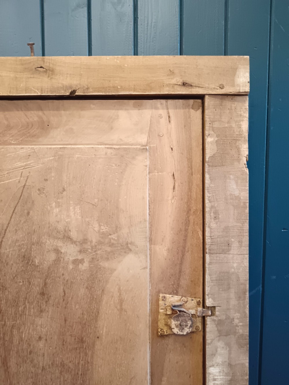 A pair of antique Italian walnut cupboard doors set within rectangular timber frames with recessed panels and iron hardware. View VI