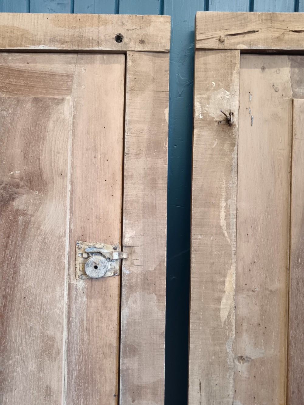 A pair of antique Italian walnut cupboard doors set within rectangular timber frames with recessed panels and iron hardware. View VII