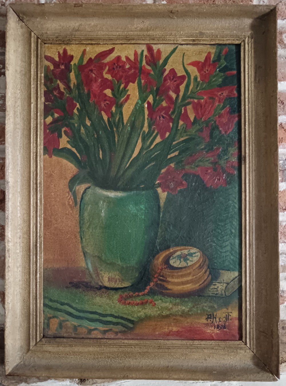 An 1896 post-impressionist oil painting depicting red flowers in a green vase alongside a wooden box and beads, set within a moulded frame.