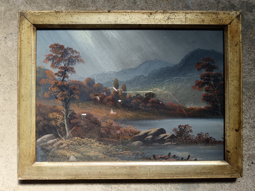 A set of four early 20th-century framed landscape paintings depicting river and woodland scenes set inside matching rectangular gilt frames. View II