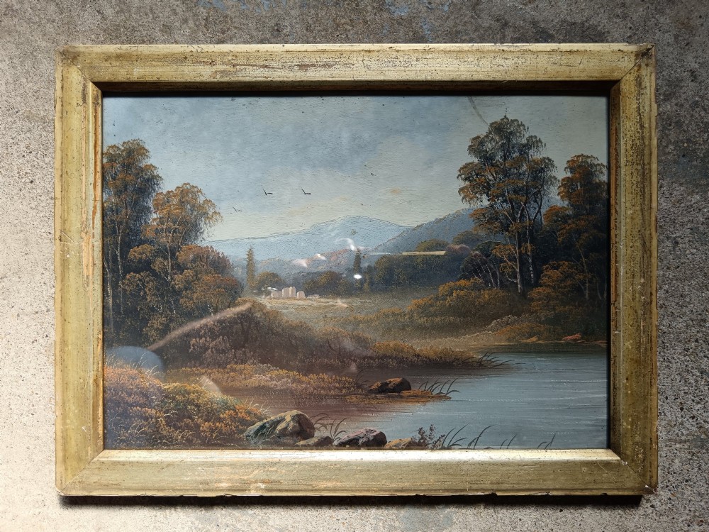 A set of four early 20th-century framed landscape paintings depicting river and woodland scenes set inside matching rectangular gilt frames. View III