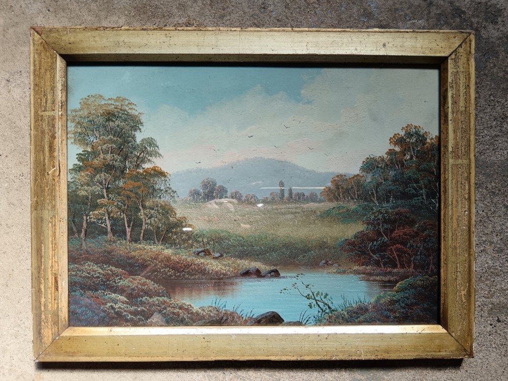 A set of four early 20th-century framed landscape paintings depicting river and woodland scenes set inside matching rectangular gilt frames. View V