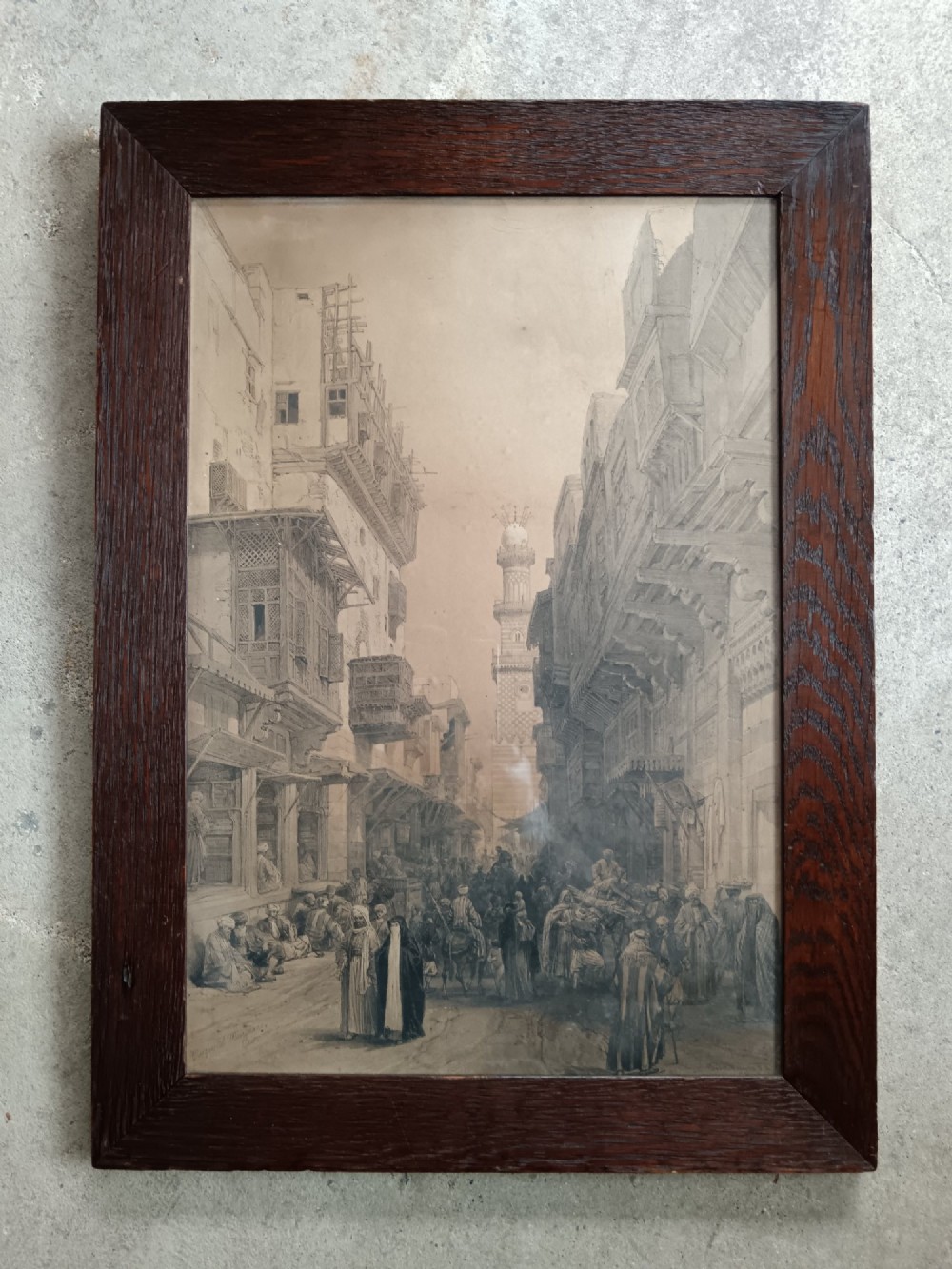 A pair of 19th-century sepia lithographs depicting architectural street and interior scenes of Cairo, mounted in dark oak frames. View III