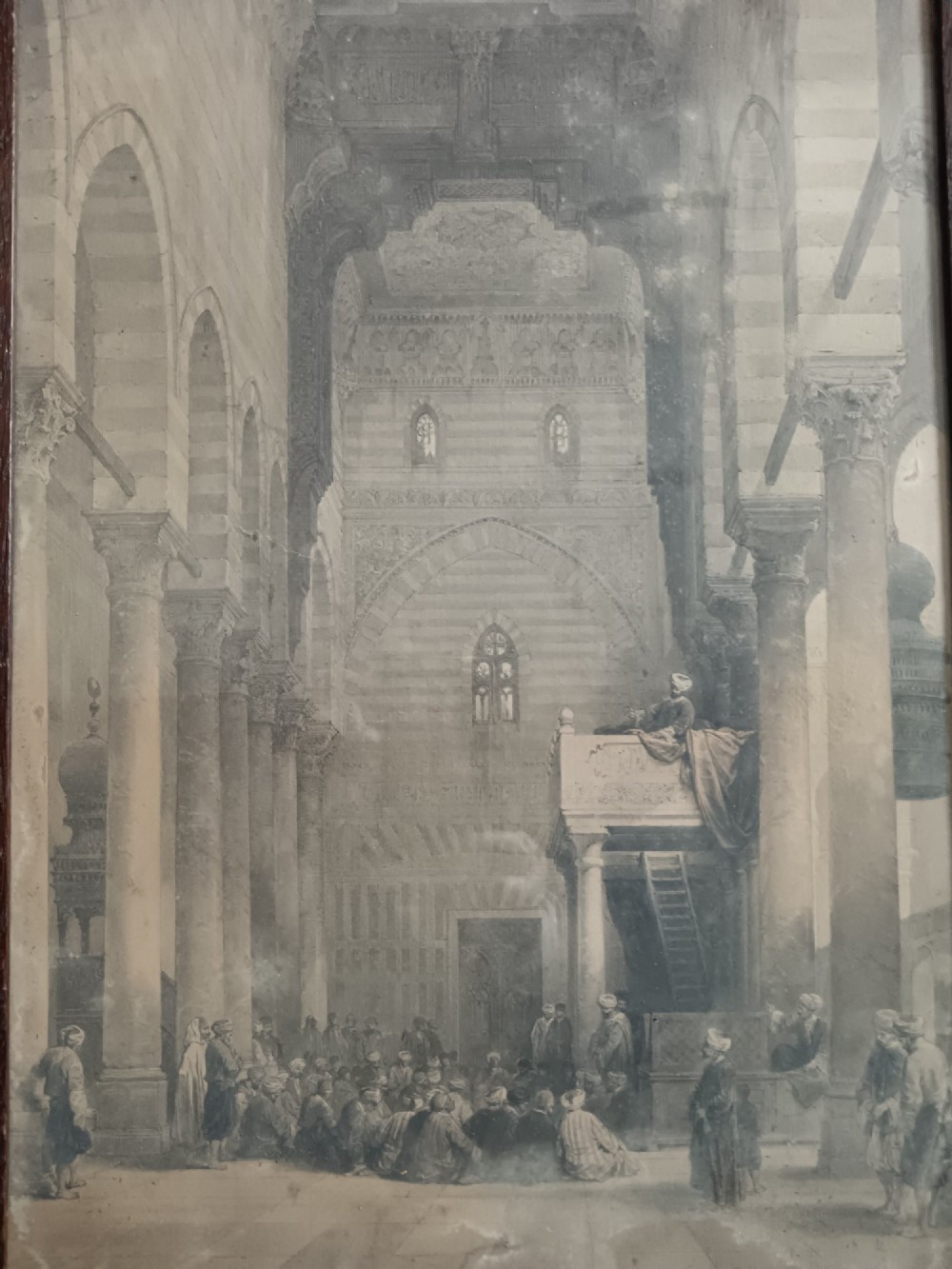 A pair of 19th-century sepia lithographs depicting architectural street and interior scenes of Cairo, mounted in dark oak frames. View VI