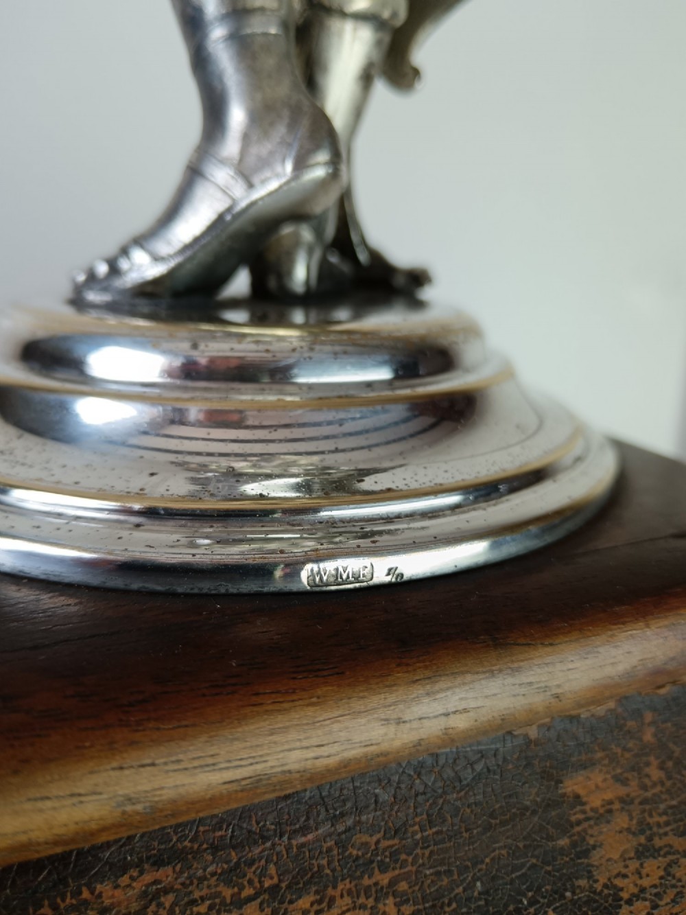 A dark wood tapered fluted pedestal column topped with a silver-plated classical female figural lamp fixture. View X