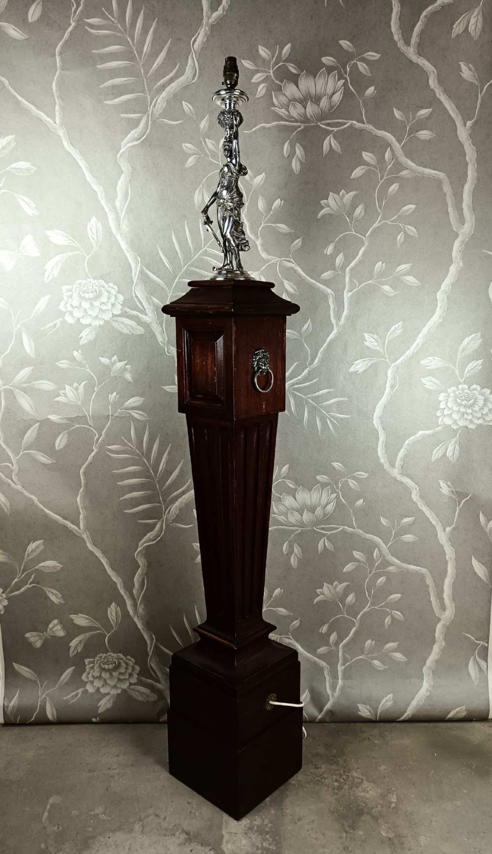 A dark wood tapered fluted pedestal column topped with a silver-plated classical female figural lamp fixture. View XI