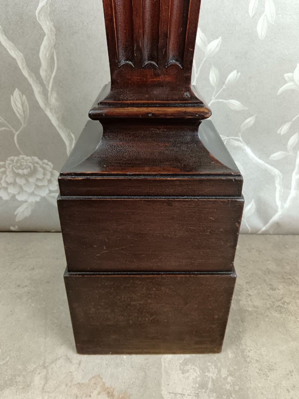 A dark wood tapered fluted pedestal column topped with a silver-plated classical female figural lamp fixture. View XII