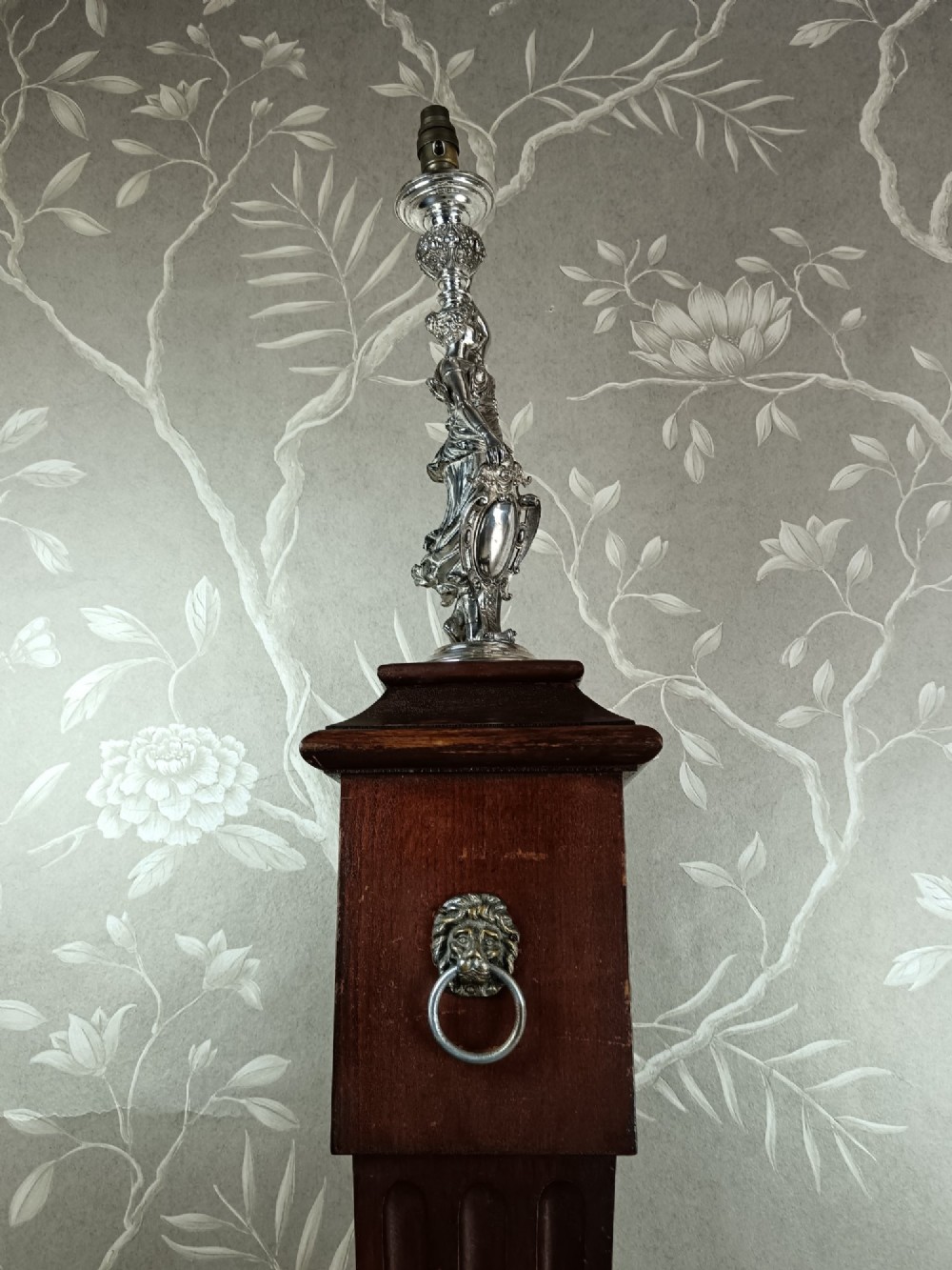 A dark wood tapered fluted pedestal column topped with a silver-plated classical female figural lamp fixture. View XIII