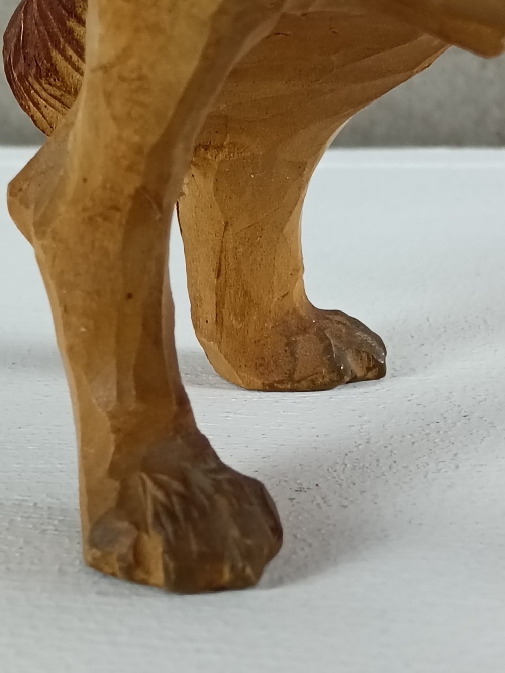 A carved and painted wooden sculpture of a standing Saint Bernard dog wearing a barrel around its neck. View VI