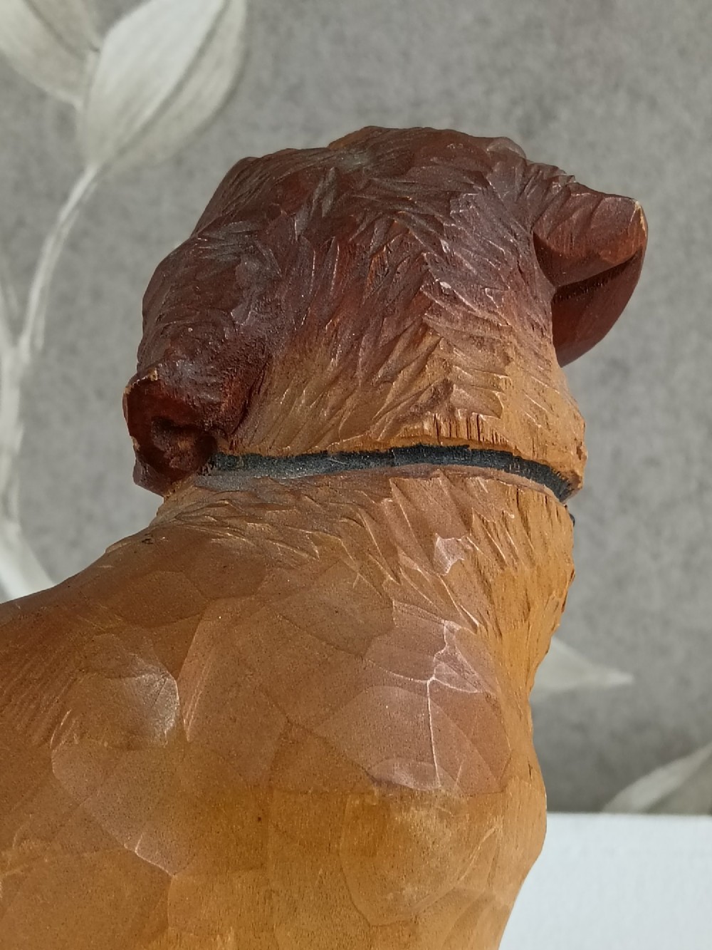 A carved and painted wooden sculpture of a standing Saint Bernard dog wearing a barrel around its neck. View VIII