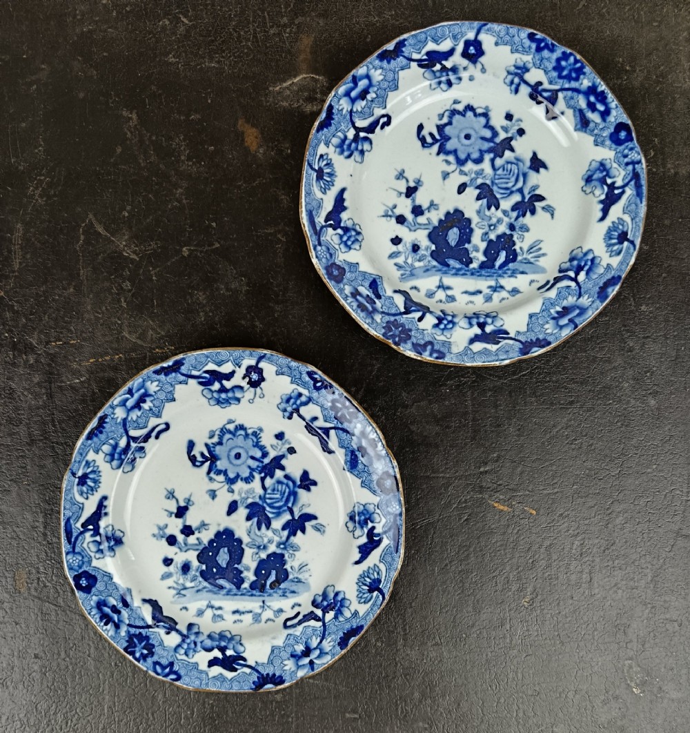 A pair of circular Georgian ceramic tea plates featuring blue and white floral underglaze decoration with scalloped edges. View II