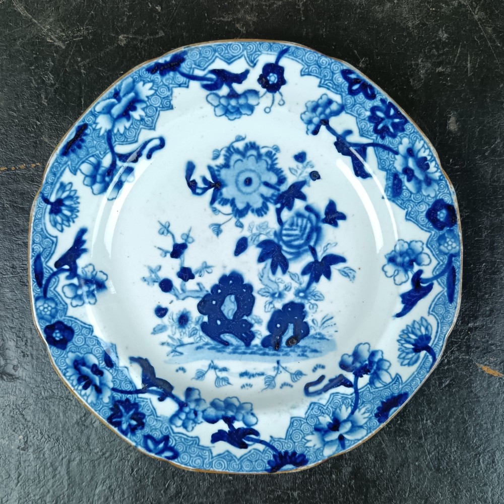A pair of circular Georgian ceramic tea plates featuring blue and white floral underglaze decoration with scalloped edges. View III