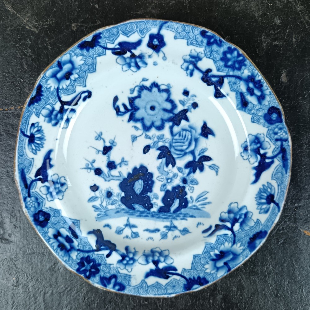 A pair of circular Georgian ceramic tea plates featuring blue and white floral underglaze decoration with scalloped edges. View IV