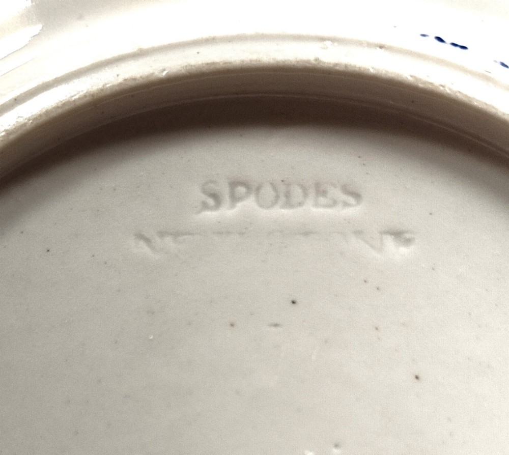 A pair of circular Georgian ceramic tea plates featuring blue and white floral underglaze decoration with scalloped edges. View V
