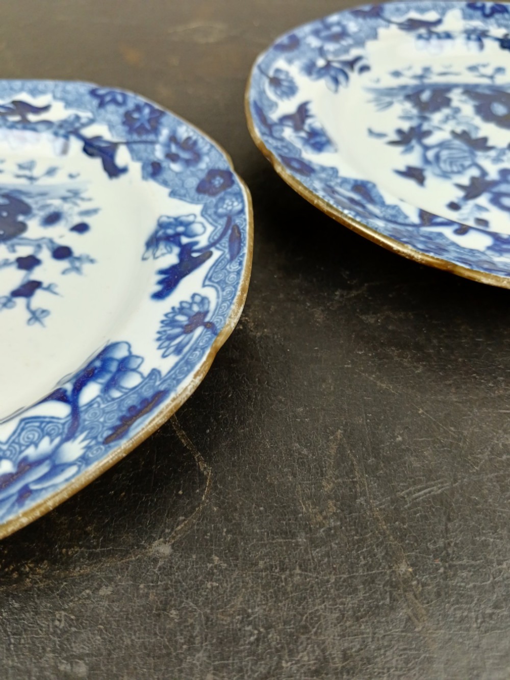 A pair of circular Georgian ceramic tea plates featuring blue and white floral underglaze decoration with scalloped edges. View VIII