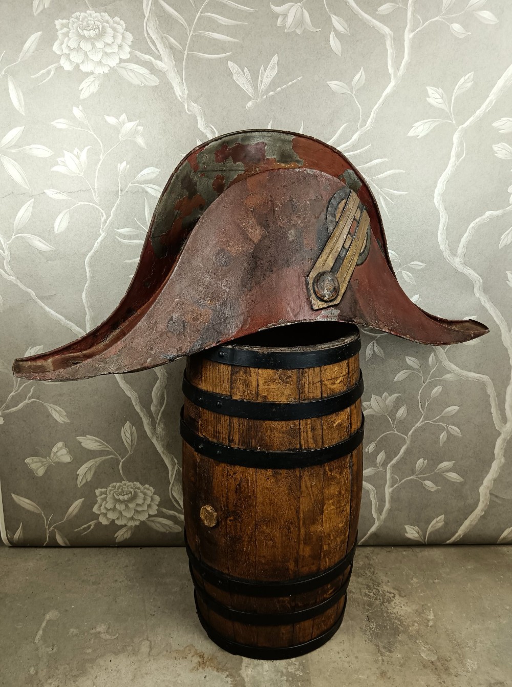 A nineteenth-century painted toleware trade sign shaped in the form of a military bicorn hat with gilt detailing. View VI