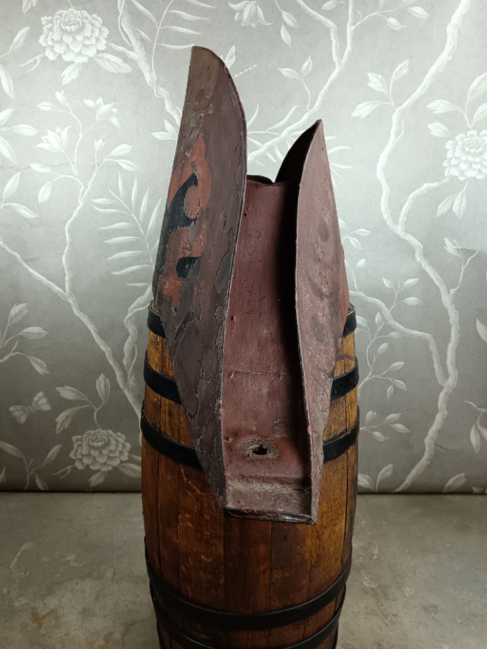 A nineteenth-century painted toleware trade sign shaped in the form of a military bicorn hat with gilt detailing. View VIII