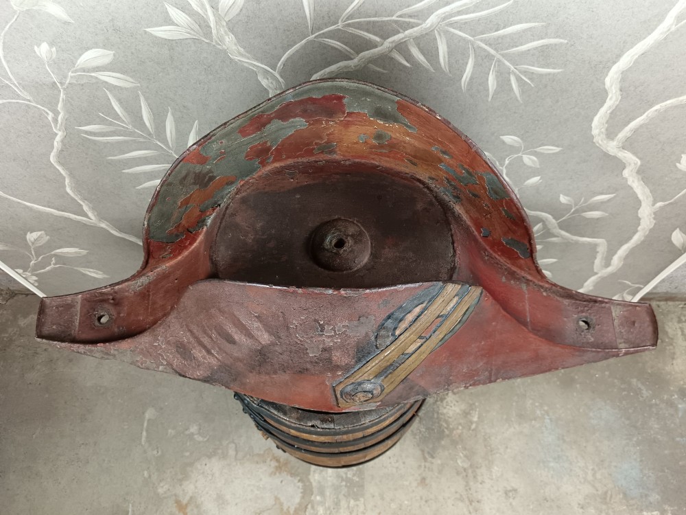A nineteenth-century painted toleware trade sign shaped in the form of a military bicorn hat with gilt detailing. View IX