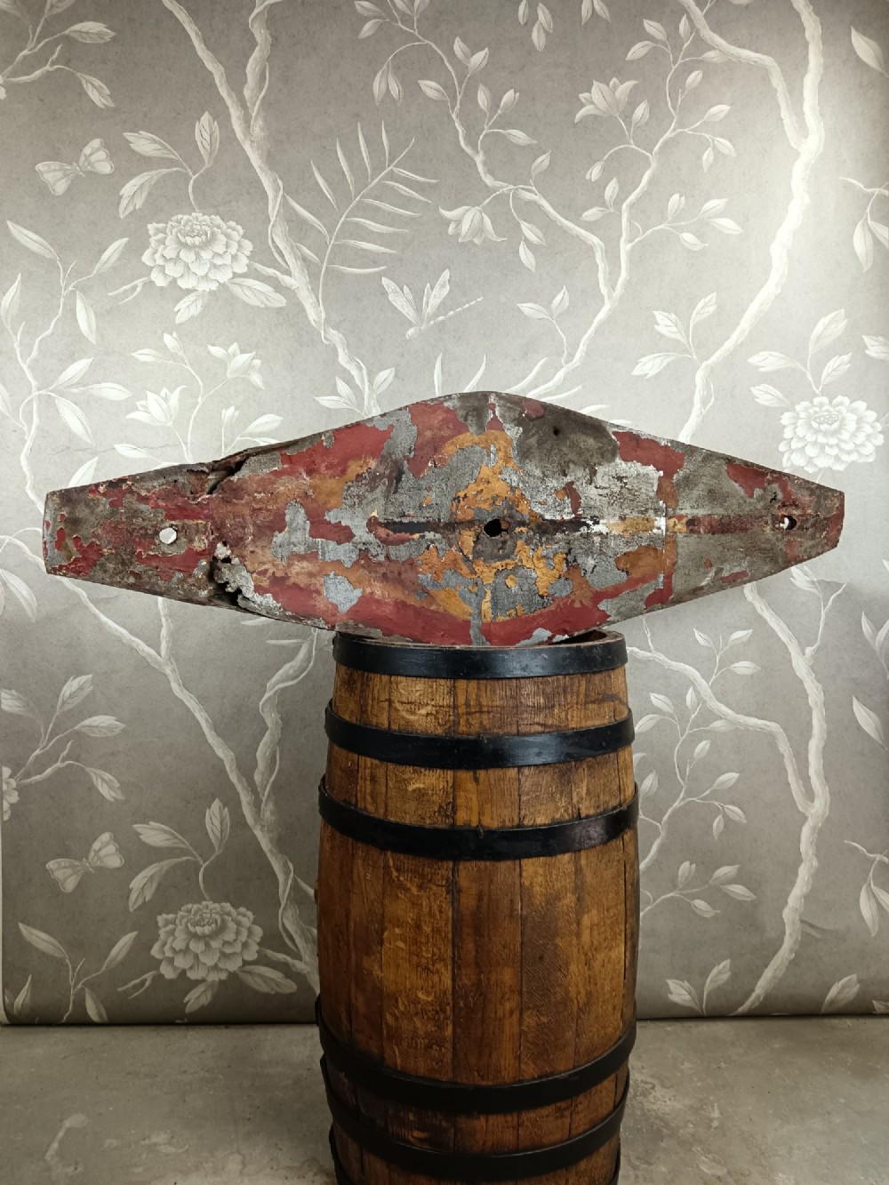A nineteenth-century painted toleware trade sign shaped in the form of a military bicorn hat with gilt detailing. View X