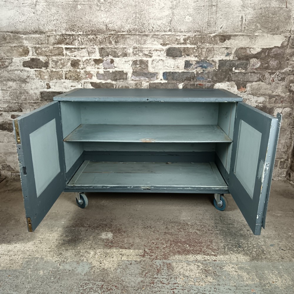 A 19th-century wooden military transport packing case featuring a slate grey painted finish and panelled front doors set on castors. View III