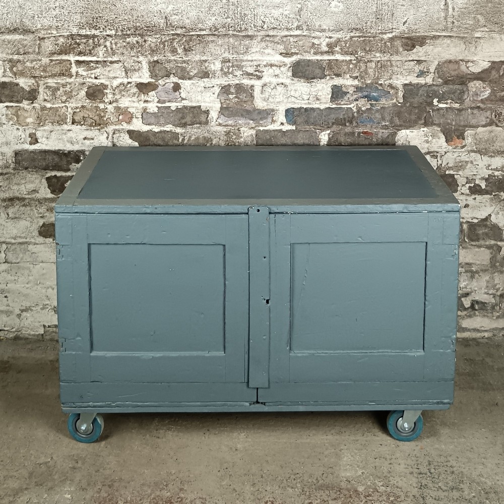 A 19th-century wooden military transport packing case featuring a slate grey painted finish and panelled front doors set on castors. View IV