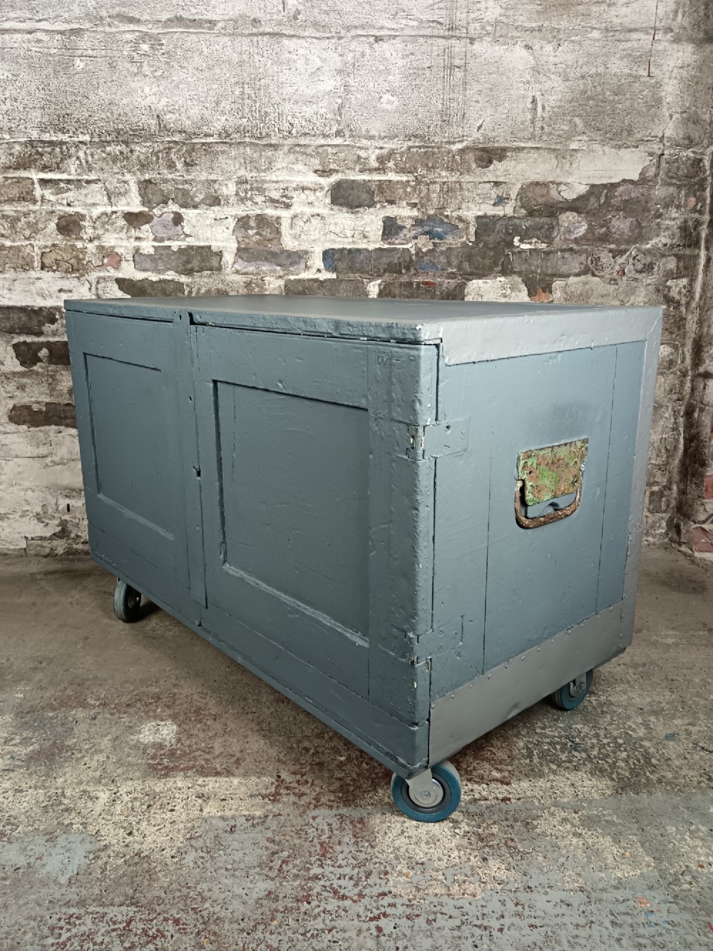 A 19th-century wooden military transport packing case featuring a slate grey painted finish and panelled front doors set on castors. View VI
