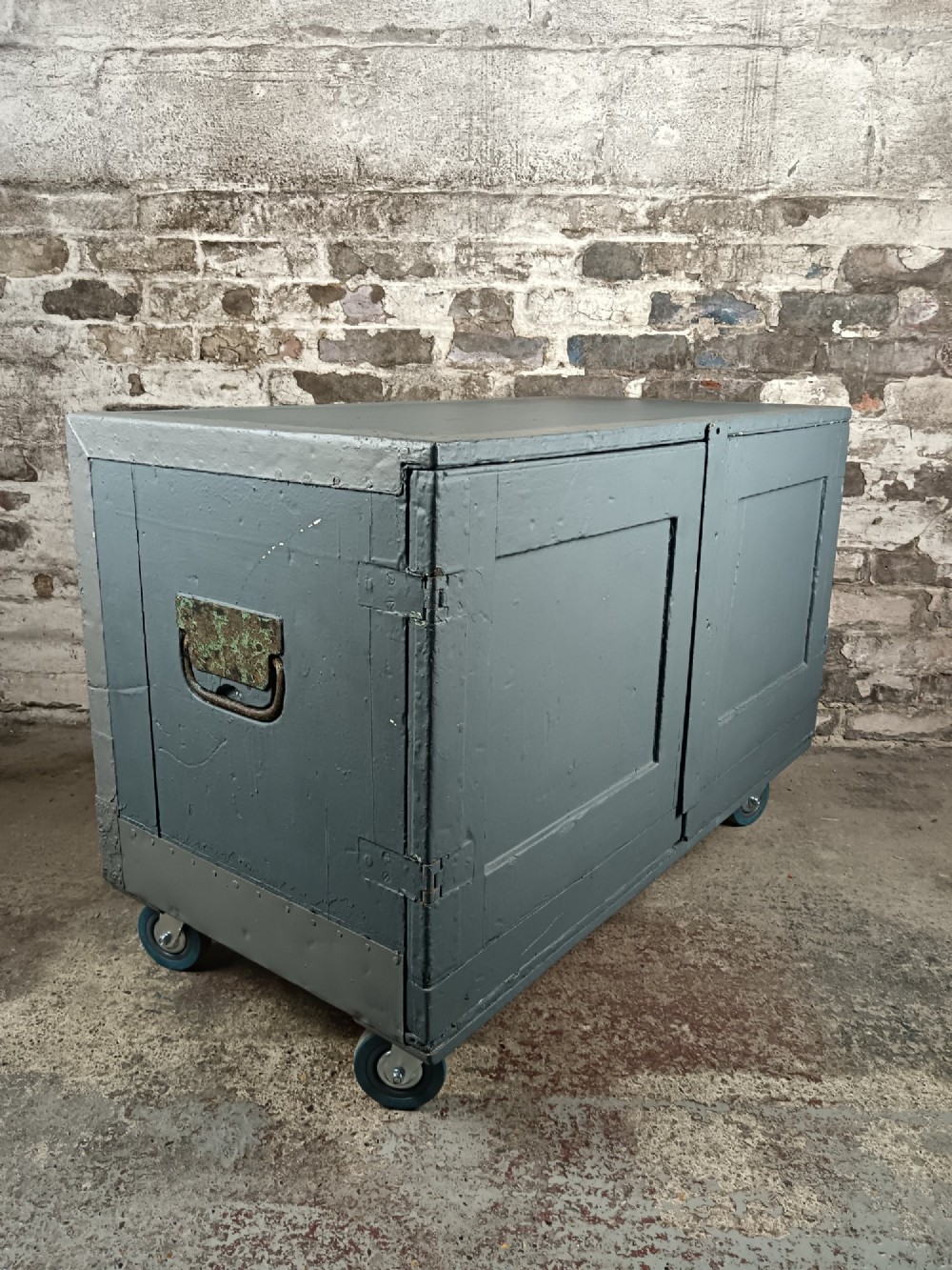 A 19th-century wooden military transport packing case featuring a slate grey painted finish and panelled front doors set on castors. View VII