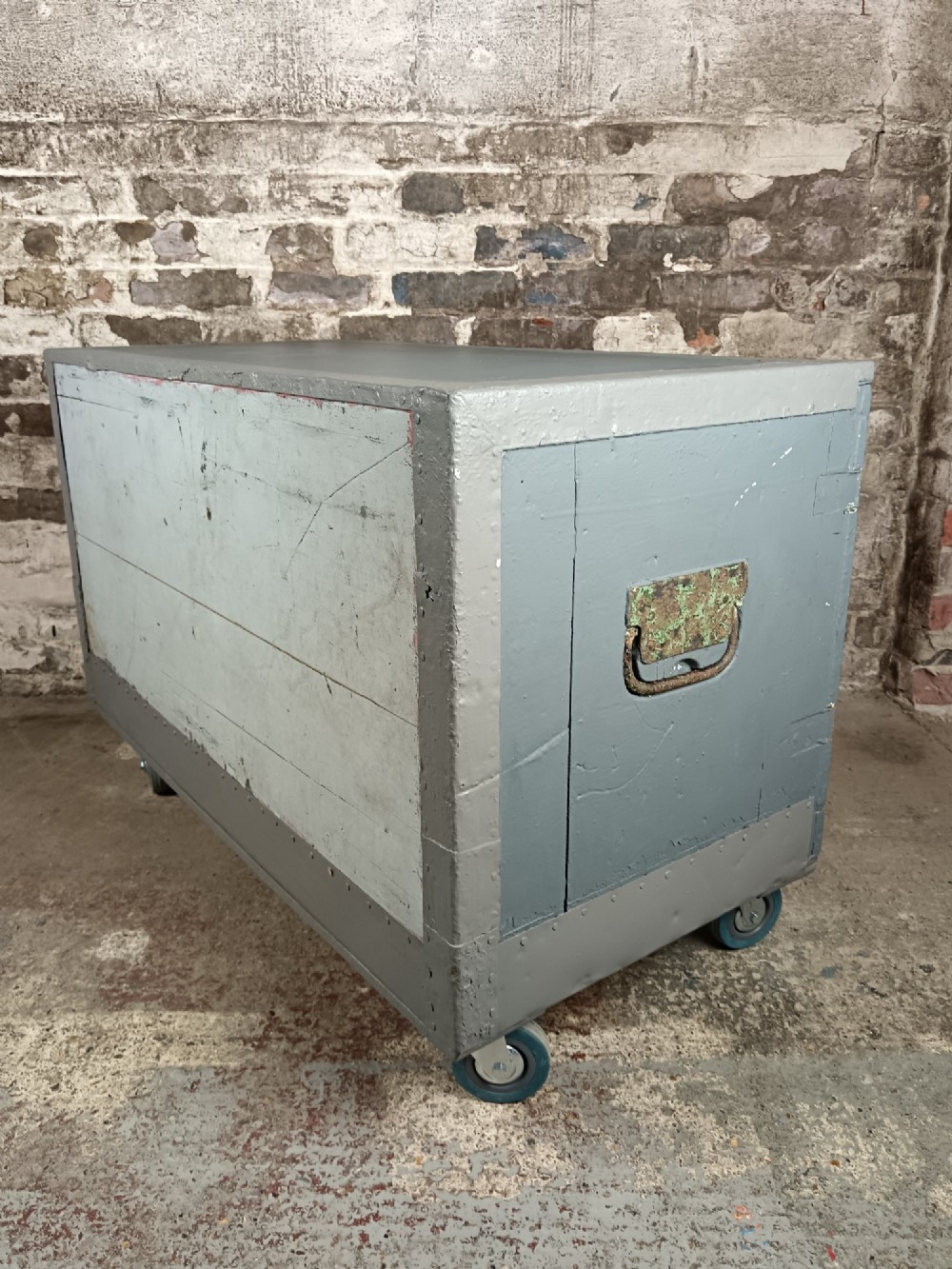 A 19th-century wooden military transport packing case featuring a slate grey painted finish and panelled front doors set on castors. View IX