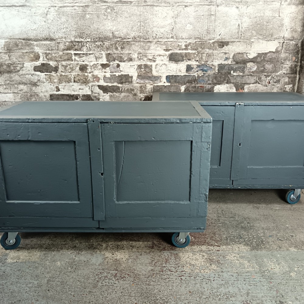 A 19th-century wooden military transport packing case featuring a slate grey painted finish and panelled front doors set on castors. View X