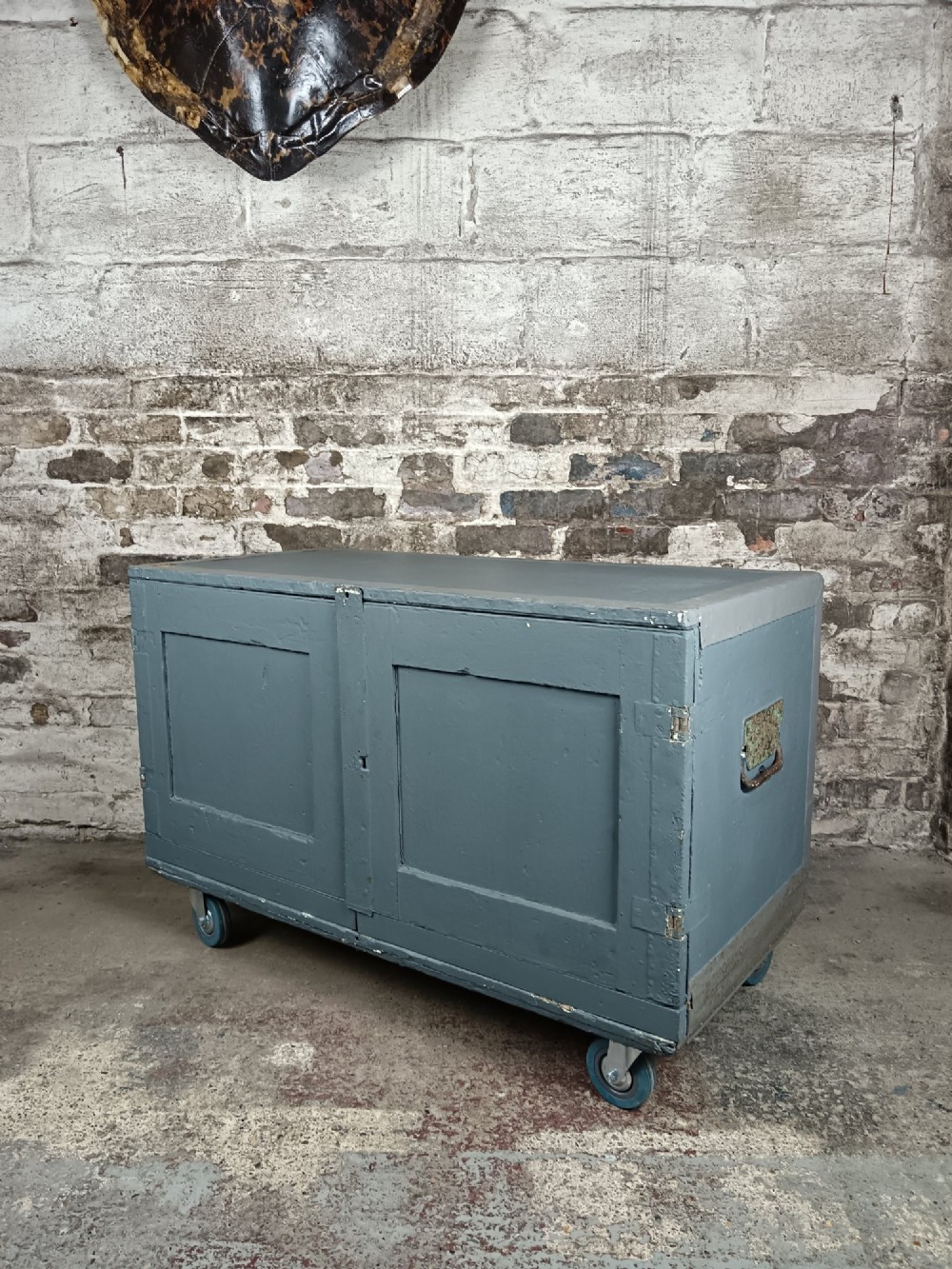 A slate grey painted 19th-century military campaign packing chest with iron flush handles, corner reinforcements, hinged doors, and an internal shelf. View IV